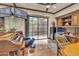 A versatile living space with hardwood floors, built-in shelving, desk, and a sliding door to the outside at 25572 N 113Th Way, Scottsdale, AZ 85255