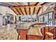 An expansive living area is adjacent to the kitchen, featuring wood beam ceilings and stone fireplace at 25572 N 113Th Way, Scottsdale, AZ 85255