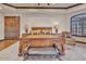 A main bedroom with decorative wooden bedframe, tray ceiling, and bedside tables with elegant lamps at 25572 N 113Th Way, Scottsdale, AZ 85255