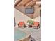 A serene patio area next to a pool, featuring comfortable seating and an outdoor television at 25572 N 113Th Way, Scottsdale, AZ 85255