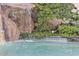 Picturesque rock waterfall feature enhancing the luxurious pool area with lush greenery surrounding the space at 25572 N 113Th Way, Scottsdale, AZ 85255