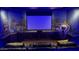 Private home theater featuring comfortable seating, large screen, custom artwork and immersive lighting at 25572 N 113Th Way, Scottsdale, AZ 85255