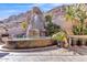 A stunning tiered water feature and desert landscape create a serene outdoor living space at 25572 N 113Th Way, Scottsdale, AZ 85255