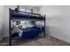 Bedroom featuring a bunk bed with blue painted frame, carpet, and small window at 29318 N 224Th Dr, Wittmann, AZ 85361