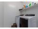 Laundry room with a washer and dryer, step stool and storage shelves at 29318 N 224Th Dr, Wittmann, AZ 85361