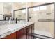 Bathroom featuring granite counters, stylish cabinetry, and tiled shower with glass door at 300 N Gila Springs Blvd # 160, Chandler, AZ 85226