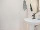A pedestal sink with a modern faucet and a round mirror in a well-lit bathroom at 300 N Gila Springs Blvd # 160, Chandler, AZ 85226
