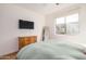A well-lit bedroom includes a wall-mounted TV, a dresser, and a full-length mirror at 300 N Gila Springs Blvd # 160, Chandler, AZ 85226