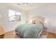 Bright bedroom featuring a ceiling fan, large window, wood floors, and stylish decor at 300 N Gila Springs Blvd # 160, Chandler, AZ 85226