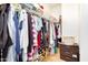 A well-organized walk-in closet with hanging clothes, shelves, and storage baskets at 300 N Gila Springs Blvd # 160, Chandler, AZ 85226