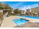 Community pool and spa surrounded by lounge chairs for relaxing, with multiple residential buildings surrounding the area at 300 N Gila Springs Blvd # 160, Chandler, AZ 85226