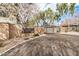 Stone community entrance with black gate and lush greenery at 300 N Gila Springs Blvd # 160, Chandler, AZ 85226