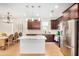Open-concept kitchen featuring dark cabinetry, stainless steel appliances, and a spacious island at 300 N Gila Springs Blvd # 160, Chandler, AZ 85226