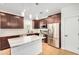 Modern kitchen featuring stainless steel appliances, a center island, and dark wood cabinets at 300 N Gila Springs Blvd # 160, Chandler, AZ 85226