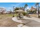 Community picnic area with mature trees and umbrellas to offer plenty of shade on a sunny day at 300 N Gila Springs Blvd # 160, Chandler, AZ 85226
