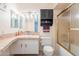 Bright bathroom features a tiled countertop, decorative lighting, and a shower with glass doors at 3107 W Tuckey Ln, Phoenix, AZ 85017