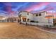 Expansive backyard featuring a two-story home, manicured landscaping, a fire pit, and a white fence at 31301 N Sunflower Way, San Tan Valley, AZ 85143