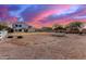 Vast backyard with a trampoline, fire pit area, swing set, pergola and a two-story home at 31301 N Sunflower Way, San Tan Valley, AZ 85143