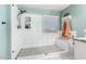 Bathroom features a tiled shower with glass door, white cabinets, quartz countertops, and stylish fixtures at 31301 N Sunflower Way, San Tan Valley, AZ 85143