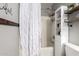 Bright bathroom featuring a shower, a toiletry organizer, and a white shower curtain at 31301 N Sunflower Way, San Tan Valley, AZ 85143