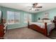 Bedroom featuring a wooden bed frame, two windows, and an installed ceiling fan at 31301 N Sunflower Way, San Tan Valley, AZ 85143
