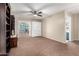 Spacious bedroom with neutral walls, carpet, and a view into an office space and bathroom at 31301 N Sunflower Way, San Tan Valley, AZ 85143