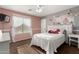 Charming bedroom decorated with flowers and accented by a plush bed and natural light at 31301 N Sunflower Way, San Tan Valley, AZ 85143