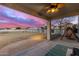 Comfortable covered patio with a ceiling fan and a view of the expansive backyard at twilight at 31301 N Sunflower Way, San Tan Valley, AZ 85143