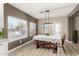 Cozy dining area with a rustic table, bench seating, and natural light from large windows at 31301 N Sunflower Way, San Tan Valley, AZ 85143