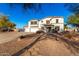 Two-story home featuring a three-car garage, desert landscaping, and a large driveway at 31301 N Sunflower Way, San Tan Valley, AZ 85143