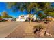 Spacious two-story home with a three-car garage, desert landscaping, and a stone walkway at 31301 N Sunflower Way, San Tan Valley, AZ 85143