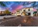 Two-story home with a three-car garage, desert landscaping, and a pathway leading to the front door at 31301 N Sunflower Way, San Tan Valley, AZ 85143