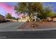 Two-story home featuring a three-car garage, desert landscaping, and a charming pathway to the entrance at 31301 N Sunflower Way, San Tan Valley, AZ 85143