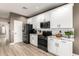 Modern kitchen with white cabinets, black appliances, and granite countertops at 31301 N Sunflower Way, San Tan Valley, AZ 85143