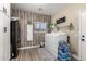 Functional laundry room with modern appliances, stylish wood-patterned wall, and storage solutions at 31301 N Sunflower Way, San Tan Valley, AZ 85143