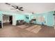 Expansive living room with neutral carpet, dual ceiling fans, and ample space for various activities at 31301 N Sunflower Way, San Tan Valley, AZ 85143