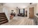 Comfortable living room with a piano, wood floors, and a staircase, blending classic charm with modern style at 31301 N Sunflower Way, San Tan Valley, AZ 85143