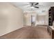 Spacious carpeted living room featuring a ceiling fan and view to another bedroom at 31301 N Sunflower Way, San Tan Valley, AZ 85143