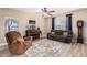 Cozy living room with wood floors, a ceiling fan, and comfortable seating, creating a relaxing atmosphere at 31301 N Sunflower Way, San Tan Valley, AZ 85143
