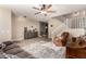 Inviting living room with a ceiling fan, grey sofa, wood-look flooring and staircase at 31301 N Sunflower Way, San Tan Valley, AZ 85143