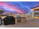 Outdoor kitchen area featuring a grill, counter space, and view of a fenced yard at 31301 N Sunflower Way, San Tan Valley, AZ 85143