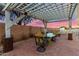 Inviting outdoor patio with pergola, dining table, and chairs, perfect for enjoying outdoor meals at 31301 N Sunflower Way, San Tan Valley, AZ 85143