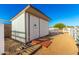 Durable storage shed with white siding and double doors, set on a gravel base at 31301 N Sunflower Way, San Tan Valley, AZ 85143