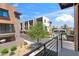 Balcony view overlooking the neighborhood, showcasing nearby townhomes and landscaping at 3233 N 70Th St # 1006, Scottsdale, AZ 85251