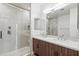 Bathroom featuring double sink vanity with stone countertop and walk-in shower with glass enclosure at 3233 N 70Th St # 1006, Scottsdale, AZ 85251
