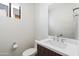 Bathroom with white counter, white toilet, and brown cabinets at 3233 N 70Th St # 1006, Scottsdale, AZ 85251