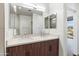 Bright bathroom featuring double sink vanity with stone countertop and walk-in shower with glass enclosure at 3233 N 70Th St # 1006, Scottsdale, AZ 85251