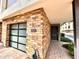 Entrance to modern condo with brick facade, attached garage, and paver sidewalk at 3233 N 70Th St # 1006, Scottsdale, AZ 85251