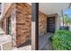 Inviting front entrance with brick accents and a modern, paneled front door at 3233 N 70Th St # 1006, Scottsdale, AZ 85251