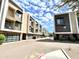 View down private street of modern condo exteriors with attached garages, sidewalks, and landscaping at 3233 N 70Th St # 1006, Scottsdale, AZ 85251
